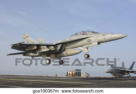 An F/A-18E Super Hornet makes an arrested landing aboard an aircraft carrier. View Large Photo Image Picture - An F/A-18E Super Hornet makes an arrested landing aboard an aircraft carrier.. Fotosearch
