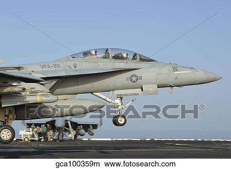 An F/A-18E Super Hornet makes an arrested landing aboard an aircraft carrier. View Large Photo Image Picture - An F/A-18E Super Hornet makes an arrested landing aboard an aircraft carrier.. Fotosearch