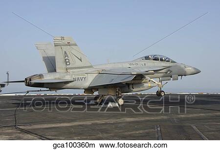 An F/A-18E Super Hornet makes an arrested landing aboard an aircraft carrier. View Large Photo Image Picture - An F/A-18E Super Hornet makes an arrested landing aboard an aircraft carrier.. Fotosearch