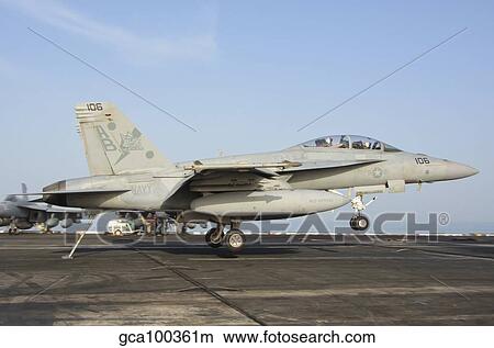 An F/A-18E Super Hornet makes an arrested landing aboard an aircraft carrier. View Large Photo Image Picture - An F/A-18E Super Hornet makes an arrested landing aboard an aircraft carrier.. Fotosearch