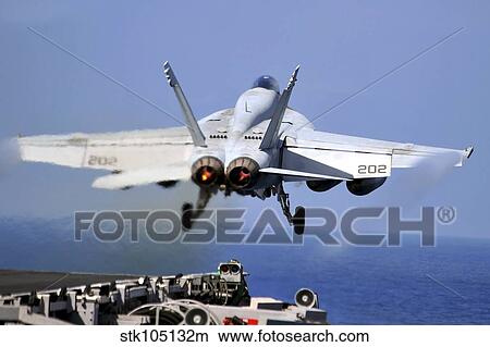 An F/A-18E Super Hornet takes off from the carrier USS Abraham Lincoln. View Large Photo Image Picture - An F/A-18E Super Hornet takes off from the carrier USS Abraham Lincoln.. Fotosearch