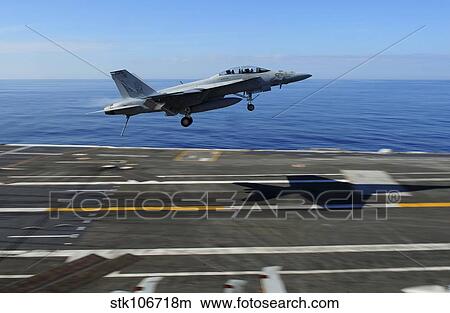 An F/A-18F Super Hornet flies over the flight deck of USS George H. W. Bush. View Large Photo Image Picture - An F/A-18F Super Hornet flies over the flight deck of USS George H. W. Bush.. Fotosearch