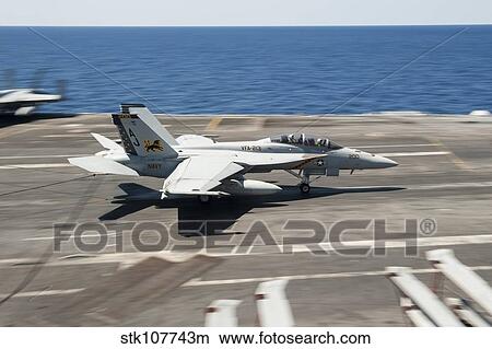 An FA-18F Super Hornet lands aboard USS George H. W. Bush. View Large Photo Image Picture - An FA-18F Super Hornet lands aboard USS George H. W. Bush.. Fotosearch