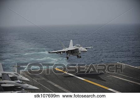 An F/A-18F Super Hornet lands on the aircraft carrier USS Nimitz. View Large Photo Image Picture - An F/A-18F Super Hornet lands on the aircraft carrier USS Nimitz.. Fotosearch