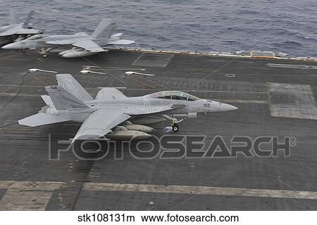 An F/A-18F Super Hornet lands on the flight deck aboard USS Nimitz. View Large Photo Image Picture - An F/A-18F Super Hornet lands on the flight deck aboard USS Nimitz.. Fotosearch