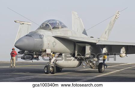 An F/A-18F Super Hornet on the flight deck of USS Theodore Roosevelt. View Large Photo Image Picture - An F/A-18F Super Hornet on the flight deck of USS Theodore Roosevelt.. Fotosearch