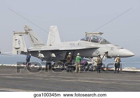 An F/A-18F Super Hornet on the flight deck of USS Theodore Roosevelt. View Large Photo Image Picture - An F/A-18F Super Hornet on the flight deck of USS Theodore Roosevelt.. Fotosearch