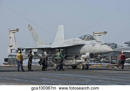 An F/A-18F Super Hornet on the flight deck of USS Theodore Roosevelt. View Large Photo Image Picture - An F/A-18F Super Hornet on the flight deck of USS Theodore Roosevelt.. Fotosearch