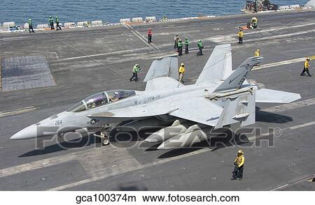 An F/A-18F Super Hornet on the flight deck of USS Theodore Roosevelt. View Large Photo Image Picture - An F/A-18F Super Hornet on the flight deck of USS Theodore Roosevelt.. Fotosearch
