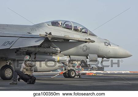 An F/A-18F Super Hornet ready to launch from a catapult. View Large Photo Image Picture - An F/A-18F Super Hornet ready to launch from a catapult.. Fotosearch