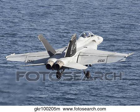An F/A-18F Super Hornet takes off during flight operations in the Arabian Sea. View Large Photo Image Picture - An F/A-18F Super Hornet takes off during flight operations in the Arabian Sea.. Fotosearch