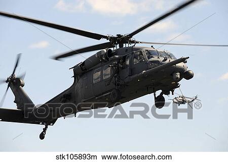 An HH-60 Pave Hawk conducts casualty recovery training. View Large Photo Image Picture - An HH-60 Pave Hawk conducts casualty recovery training.. Fotosearch