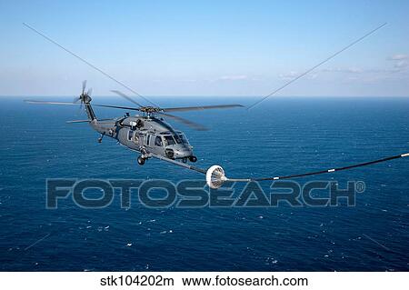 An HH-60 Pave Hawk refuels over the Pacific Ocean. View Large Photo Image Picture - An HH-60 Pave Hawk refuels over the Pacific Ocean.. Fotosearch