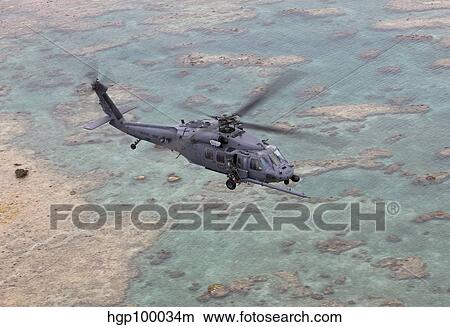 An HH-60G Pave Hawk flies along the coastline of Okinawa, Japan. View Large Photo Image Picture - An HH-60G Pave Hawk flies along the coastline of Okinawa, Japan.. Fotosearch