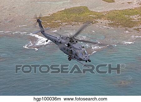 An HH-60G Pave Hawk flies along the coastline of Okinawa, Japan. View Large Photo Image Picture - An HH-60G Pave Hawk flies along the coastline of Okinawa, Japan.. Fotosearch