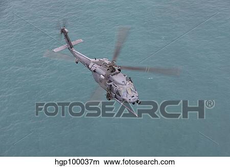 An HH-60G Pave Hawk flies along the coastline of Okinawa, Japan. View Large Photo Image Picture - An HH-60G Pave Hawk flies along the coastline of Okinawa, Japan.. Fotosearch