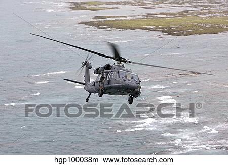 An HH-60G Pave Hawk flies along the coastline of Okinawa, Japan. View Large Photo Image Picture - An HH-60G Pave Hawk flies along the coastline of Okinawa, Japan.. Fotosearch