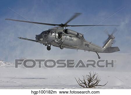 An HH-60G Pave Hawk fly's low over a landing zone in New Mexico. View Large Photo Image Picture - An HH-60G Pave Hawk fly's low over a landing zone in New Mexico.. Fotosearch