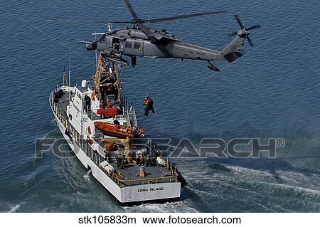 An HH-60G Pave Hawk performs a hoist over U. S. Coast Guard Cutter Long Island. View Large Photo Image Picture - An HH-60G Pave Hawk performs a hoist over U. S. Coast Guard Cutter Long Island.. Fotosearch