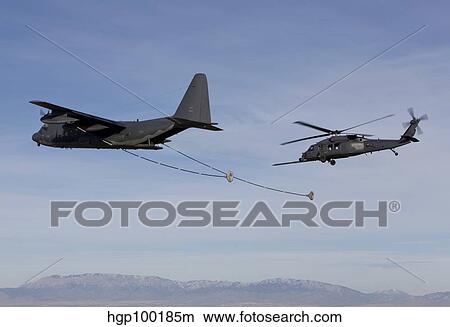 An HH-60G Pave Hawk prepares for aerial refueling from an HC-130. View Large Photo Image Picture - An HH-60G Pave Hawk prepares for aerial refueling from an HC-130.. Fotosearch
