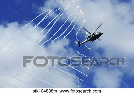 An HH-60H Sea Hawk helicopter releases countermeasure flares. View Large Photo Image Picture - An HH-60H Sea Hawk helicopter releases countermeasure flares.. Fotosearch