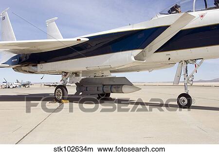 An inert AIM-54 Phoenix missile nestled under the fuselage of NASA Dryden's F-15B aircraft. View Large Photo Image Picture - An inert AIM-54 Phoenix missile nestled under the fuselage of NASA Dryden's F-15B aircraft.. Fotosearch