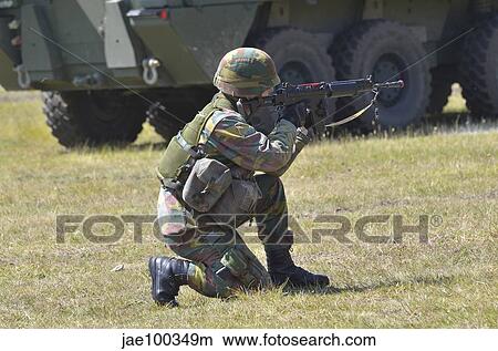 An infantry soldier of the Belgian Army aiming his FN FNC assault rifle. View Large Photo Image Picture - An infantry soldier of the Belgian Army aiming his FN FNC assault rifle.. Fotosearch