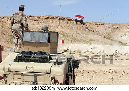 An instructor watches as an Iraqi army soldier fires a PKC machine gun. View Large Photo Image Picture - An instructor watches as an Iraqi army soldier fires a PKC machine gun.. Fotosearch