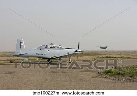 Picture - An Iraqi Air Force T-6 Texan trainer aircraft taxis out for a flight over Tikrit, Iraq.. Fotosearch