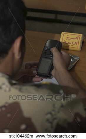 An Iraqi Army lieutenant learns how to use a handheld GPS device. View Large Photo Image Picture - An Iraqi Army lieutenant learns how to use a handheld GPS device.. Fotosearch