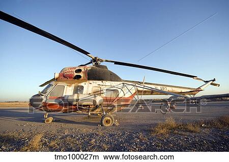 Picture - An Iraqi helicopter sits on the flight deck abandoned at Camp Warhorse.. Fotosearch