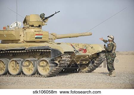 An Iraqi officer directs a T-72 tank to the firing line. View Large Photo Image Picture - An Iraqi officer directs a T-72 tank to the firing line.. Fotosearch
