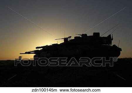Picture - An Israel Defense Force Merkava Mark IV main battle tank at sunset.. Fotosearch
