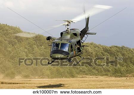 An Italian Air Force AB-212 ICO helicopter departs the landing zone, Italy. View Large Photo Image Picture - An Italian Air Force AB-212 ICO helicopter departs the landing zone, Italy.. Fotosearch