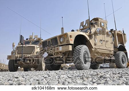 Picture - An M-ATV Mine Resistant Ambush Protected vehicle parked next to a MaxxPro MRAP.. Fotosearch