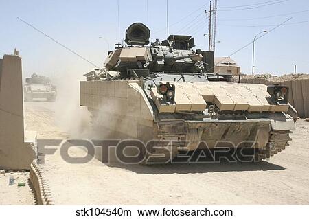 An M2 Bradley Fighting Vehicle patrols past Command Post Hit, Iraq. View Large Photo Image Picture - An M2 Bradley Fighting Vehicle patrols past Command Post Hit, Iraq.. Fotosearch
