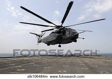 An MH-53E Sea Dragon prepares to land on the flight deck aboard USS Ponce. View Large Photo Image Picture - An MH-53E Sea Dragon prepares to land on the flight deck aboard USS Ponce.. Fotosearch