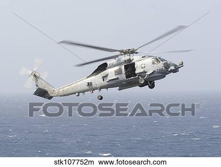 An MH-60R Sea Hawk helicopter prepares to land. View Large Photo Image Picture - An MH-60R Sea Hawk helicopter prepares to land.. Fotosearch