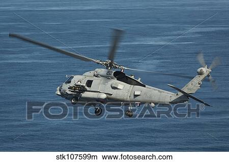 An MH-60R Sea Hawk maneuvers over the South China Sea. View Large Photo Image Picture - An MH-60R Sea Hawk maneuvers over the South China Sea.. Fotosearch