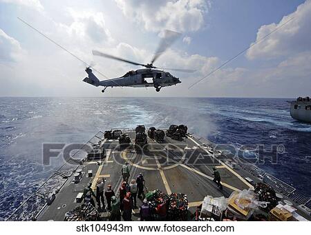 An MH-60R Sea Hawk transfers supplies to the flight deck of USS Wayne E. Meyer. View Large Photo Image Picture - An MH-60R Sea Hawk transfers supplies to the flight deck of USS Wayne E. Meyer.. Fotosearch