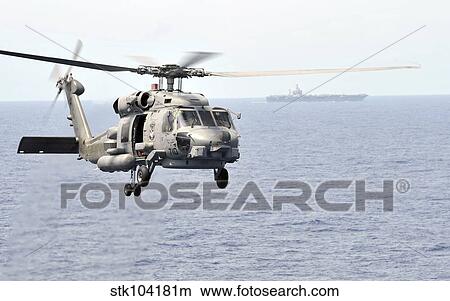 An MH-60R Seahawk helicopter in flight over the Pacific Ocean. View Large Photo Image Picture - An MH-60R Seahawk helicopter in flight over the Pacific Ocean.. Fotosearch