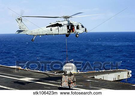 An MH-60R Seahawk helicopter places cargo onto the flight deck of USS Nimitz. View Large Photo Image Picture - An MH-60R Seahawk helicopter places cargo onto the flight deck of USS Nimitz.. Fotosearch