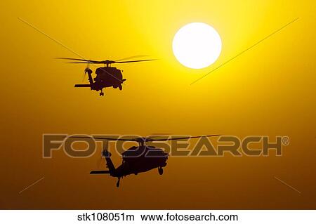 An MH-60S Knighthawk and MH-60R Sea Hawk at sunset. View Large Photo Image Picture - An MH-60S Knighthawk and MH-60R Sea Hawk at sunset.. Fotosearch