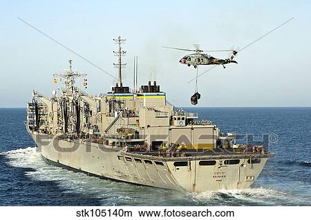 An MH-60S Knighthawk lifts cargo from the fast combat support ship USNS Rainier. View Large Photo Image Picture - An MH-60S Knighthawk lifts cargo from the fast combat support ship USNS Rainier.. Fotosearch