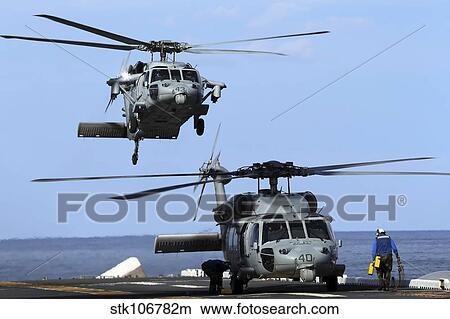 An MH-60S Sea Hawk approaches the amphibious assault ship USS Kearsarge. View Large Photo Image Picture - An MH-60S Sea Hawk approaches the amphibious assault ship USS Kearsarge.. Fotosearch