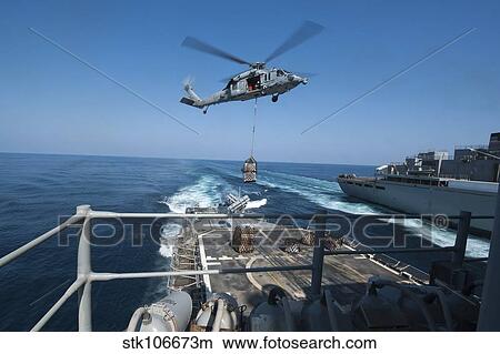 An MH-60S Sea Hawk brings pallets of supplies to USS Mobile Bay. View Large Photo Image Picture - An MH-60S Sea Hawk brings pallets of supplies to USS Mobile Bay.. Fotosearch