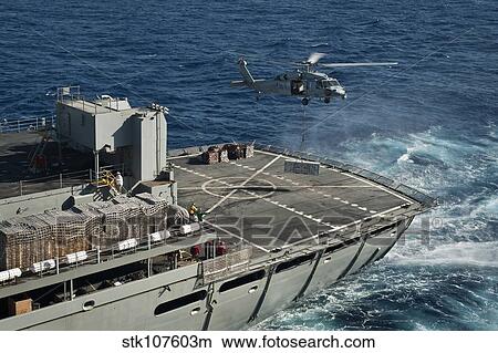 An MH-60S Sea Hawk conducts a vertical replenishment with USNS Rainier. View Large Photo Image Picture - An MH-60S Sea Hawk conducts a vertical replenishment with USNS Rainier.. Fotosearch
