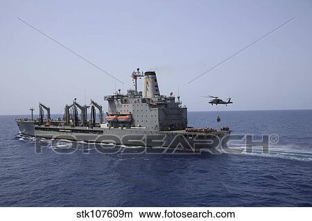 An MH-60S Sea Hawk conducts a vertical replenishment with USNS Laramie. View Large Photo Image Picture - An MH-60S Sea Hawk conducts a vertical replenishment with USNS Laramie.. Fotosearch