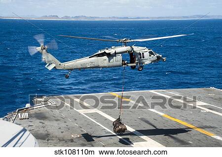 An MH-60S Sea Hawk delivers supplies onto the flight deck of USS George Washington. View Large Photo Image Picture - An MH-60S Sea Hawk delivers supplies onto the flight deck of USS George Washington.. Fotosearch