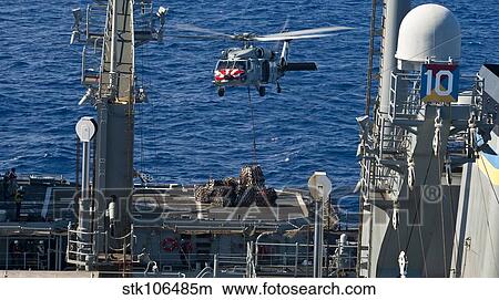 An MH-60S Sea Hawk delivers supplies to the flight deck of USS Mobile Bay. View Large Photo Image Picture - An MH-60S Sea Hawk delivers supplies to the flight deck of USS Mobile Bay.. Fotosearch